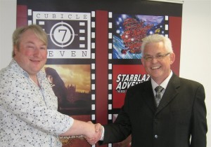 Dominic McDowall-Thomas (CEO:Cubicle 7) and Joe Dever celebrating the signing of a major Lone Wolf deal.