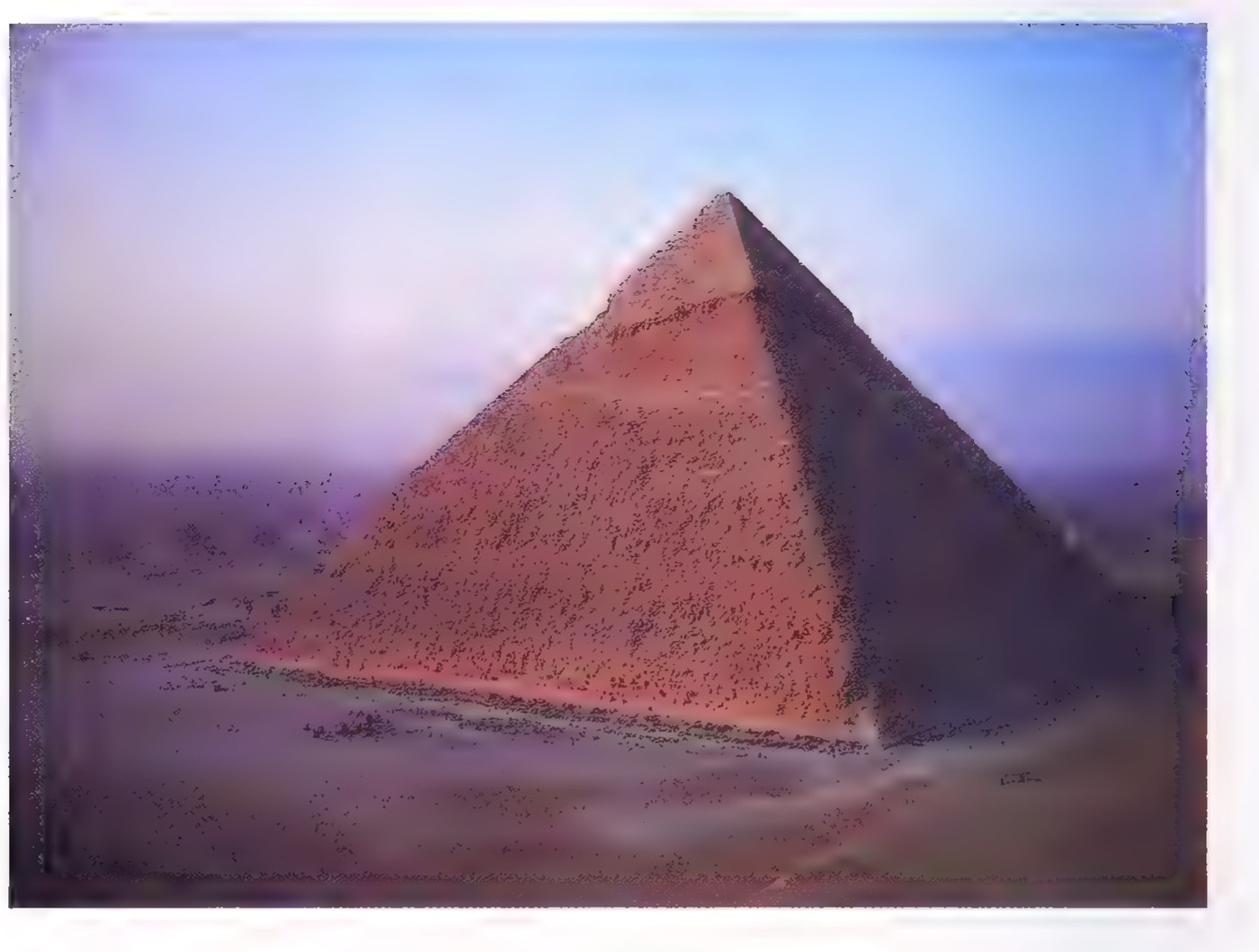 Photograph of the Great Pyramid at Giza rising out of the desert.
