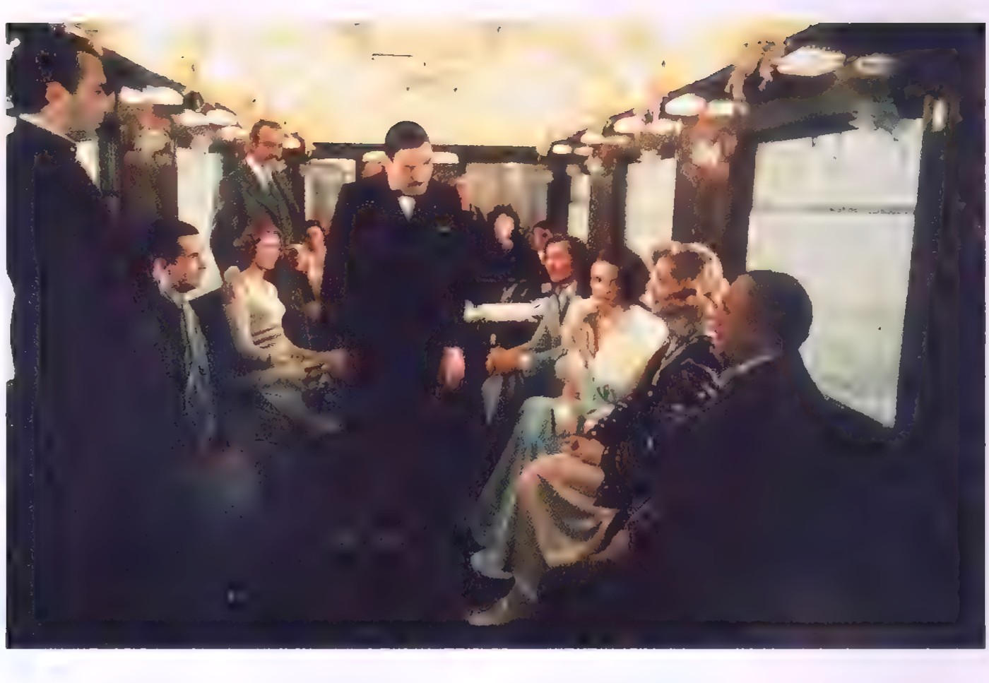 Movie still of Hercule Poirot seated in a train compartment, with other passengers behind him.