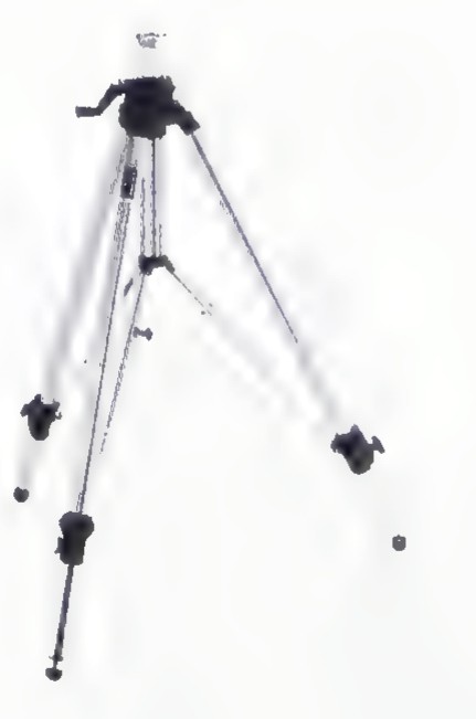 A camera on a three-legged tripod.