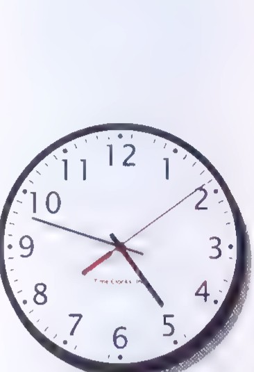 A photograph of a round wall clock with numbers 1 through 12.