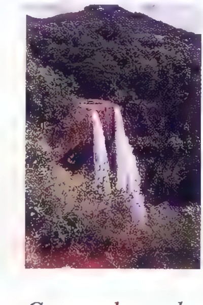 A photograph of a tall waterfall dropping into a forest pool.
