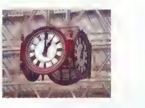 A photograph of an old pocket watch in a wooden case, its hands pointing to about 5 o’clock.