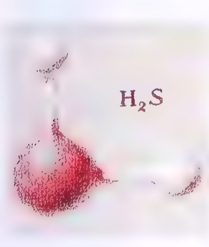 A foggy photograph of hydrogen sulfide gas above a red substance.