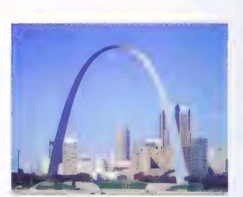 Photograph of the Gateway Arch in St. Louis, a tall, wide steel catenary curve rising above the city skyline.