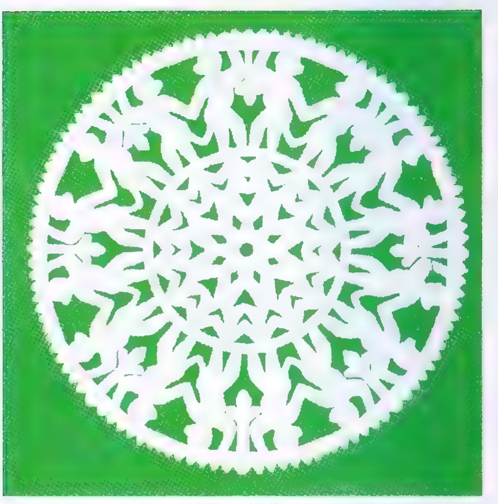 Circular papercut of interlocking white monkey figures against a green background.