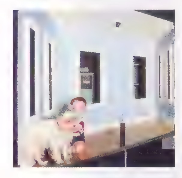 Small photograph of the same room taken from a different angle, showing its slanted floor and ceiling.