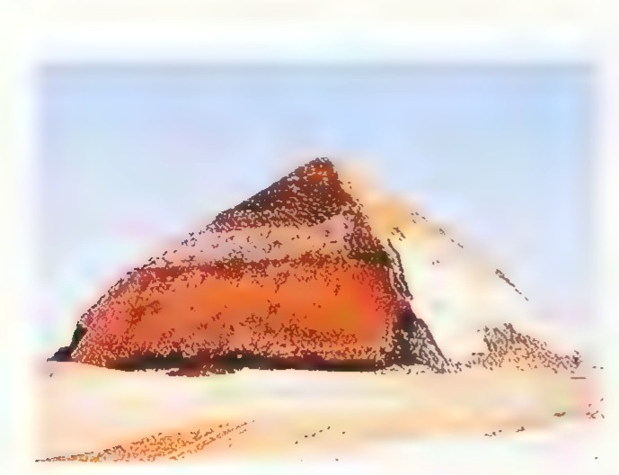 Photograph of the Bent Pyramid at Dahshur rising from the desert.