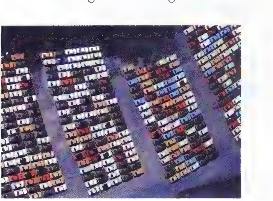 Aerial photograph of a large parking area filled with rows of new cars.