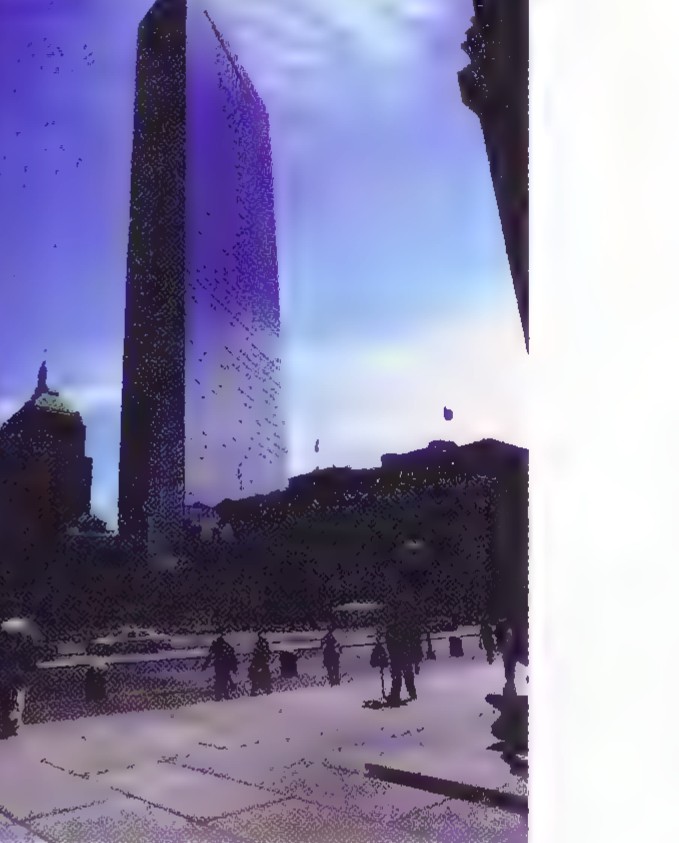Photograph of the John Hancock Tower, a tall glass building rising above lower city buildings.