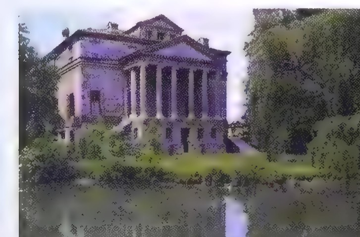 A photograph of the Villa Foscari, a Renaissance villa with a pedimented portico, seen across water.