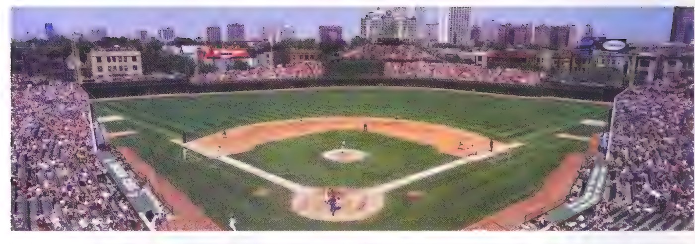 Photograph of a baseball game in a packed stadium, seen from high above the outfield.