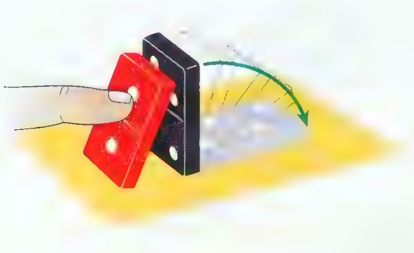 Photograph of a hand pushing the first in a line of large black dominoes with red spots, with yellow shading behind them.
