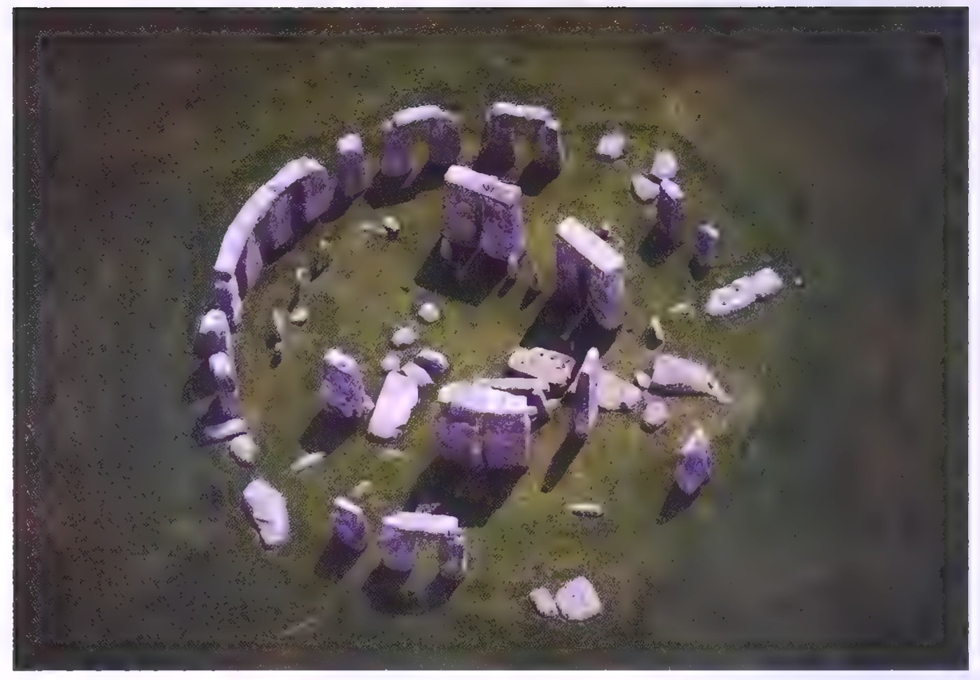 Aerial view of Stonehenge: a circular arrangement of large standing stones on a grassy plain.