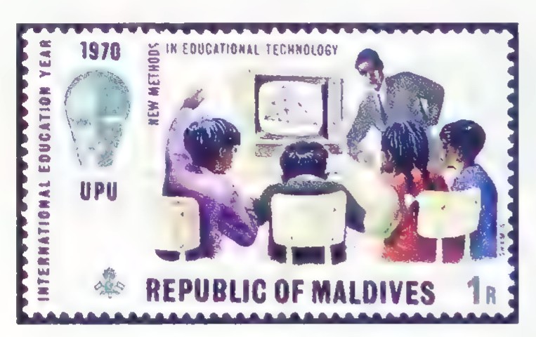 Postage stamp from the Republic of Maldives showing a teacher and students with a television monitor, issued for International Education Year.