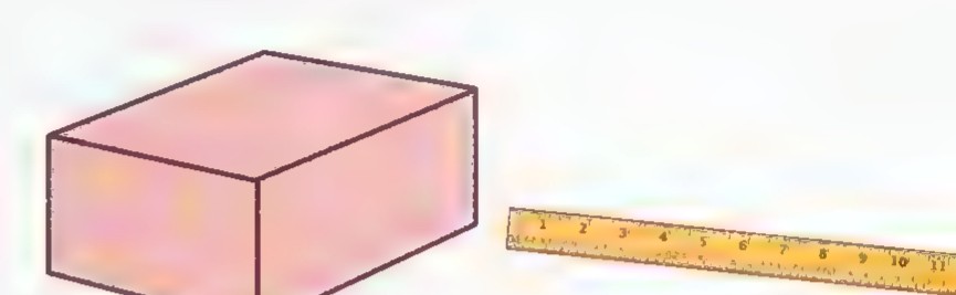 A brick beside a ruler, drawn in perspective.