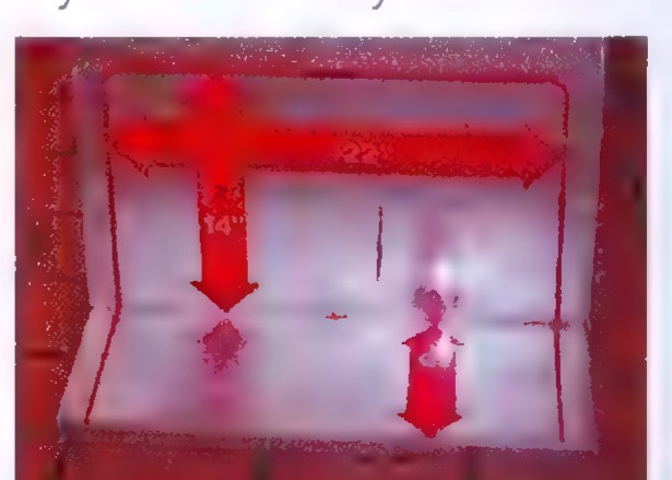 A red suitcase seen through an X-ray scanner, with its outline marked with dimension arrows.