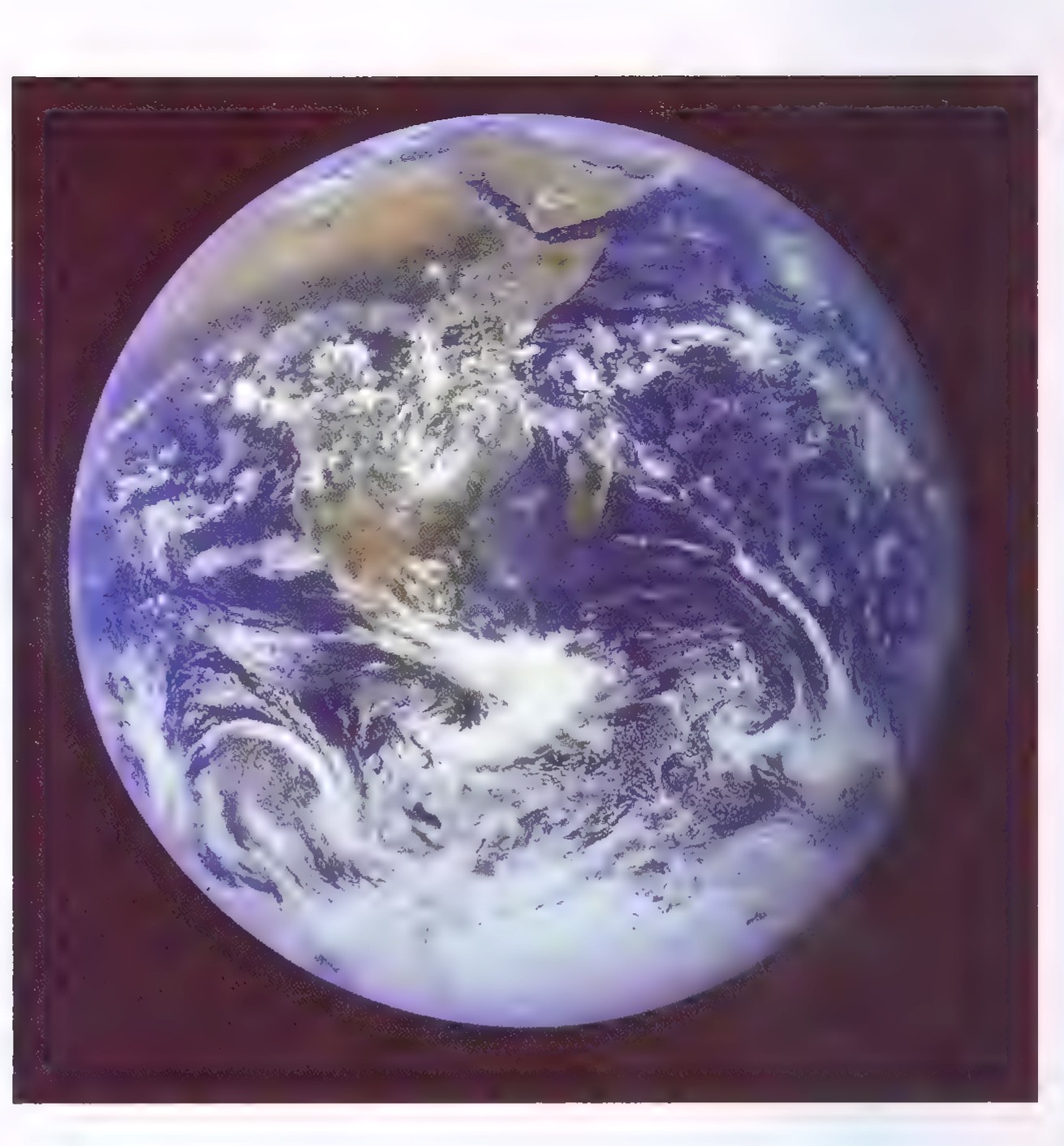 Photograph of Earth from space, showing Africa at the upper left, cloud swirls, and snow-covered Antarctica at the bottom.