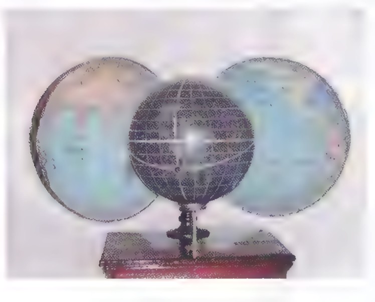Photograph of a hollow-earth model: a transparent sphere with a small globe inside it, mounted on a stand.