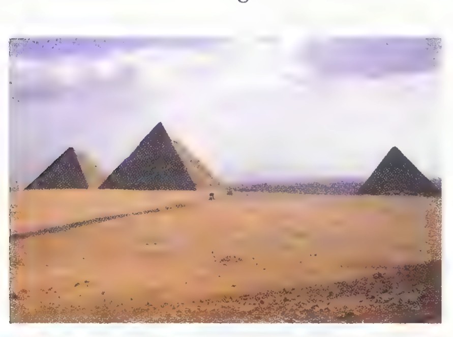 Photograph of three pyramids on the desert plain at Giza under a hazy sky.